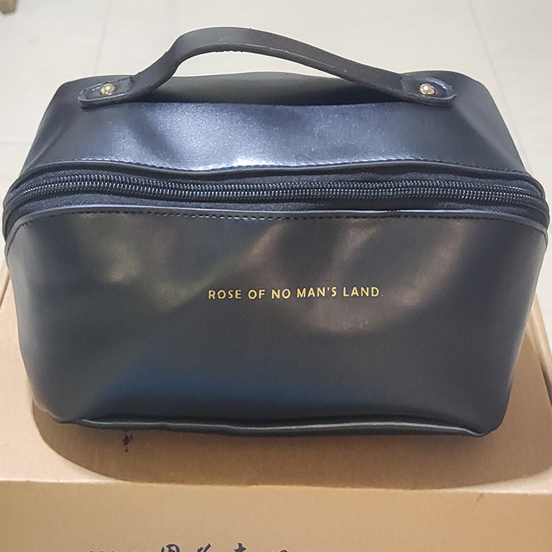 Black large travel cosmetic bag with top handle and front zipper pocket