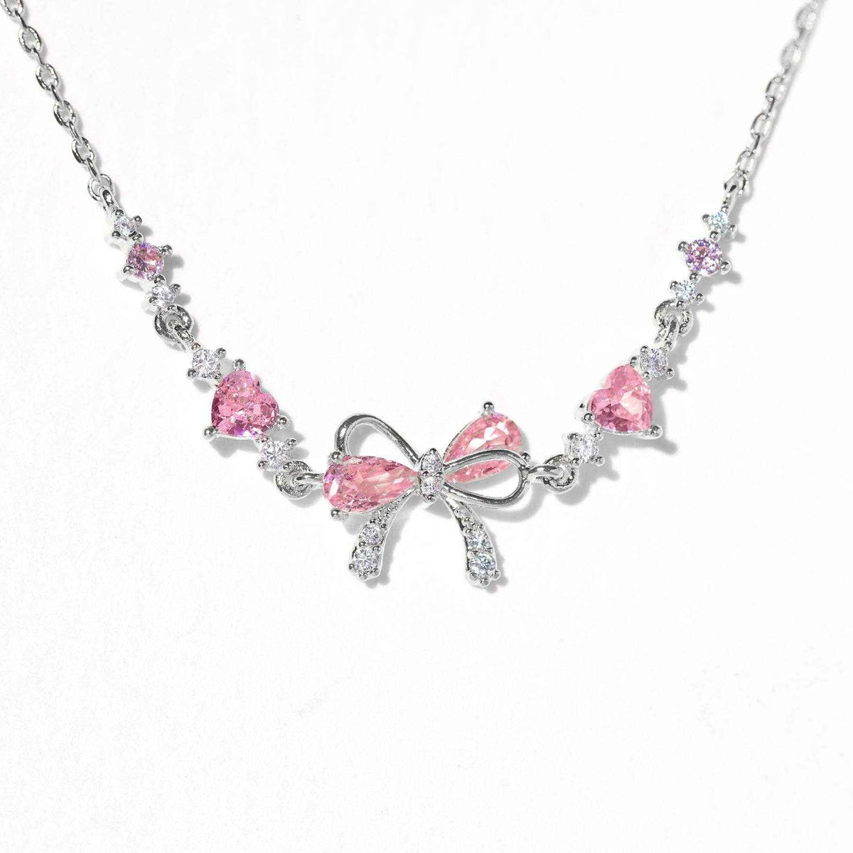 Silver chain bracelet with pink heart and bow rhinestone charm, adjustable clasp