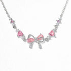 Silver chain bracelet with pink heart and bow rhinestone charm, adjustable clasp