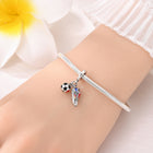 Silver-tone charm bead with soccer ball and player figure on a bracelet bangle