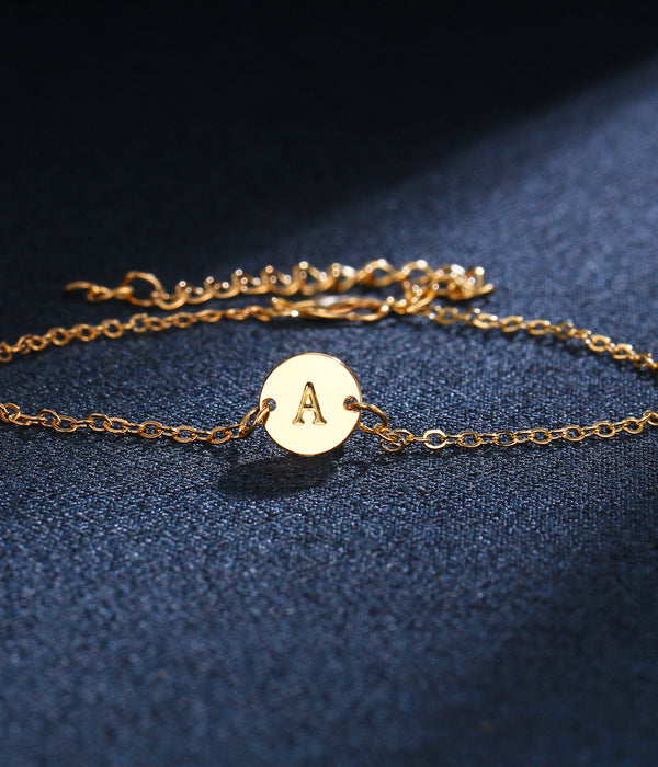 Gold-tone chain bracelet with round initial charm letter A