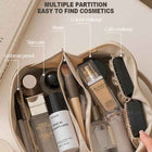 Beige cosmetic bag with multiple inner partitions, open zip top for organizing makeup