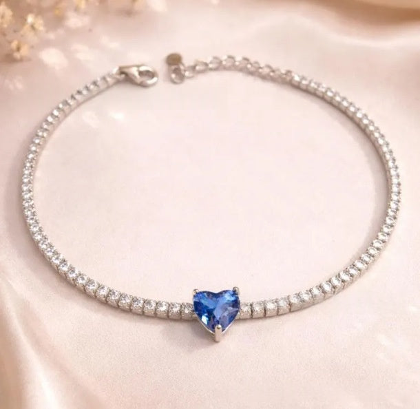 Silver-tone zircon bracelet featuring a blue heart-shaped center stone