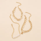 Gold-tone linked chain bracelet with pearl beads and dangling coin charm