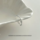 Silver-tone open bow link ring with adjustable clasp, minimalist design