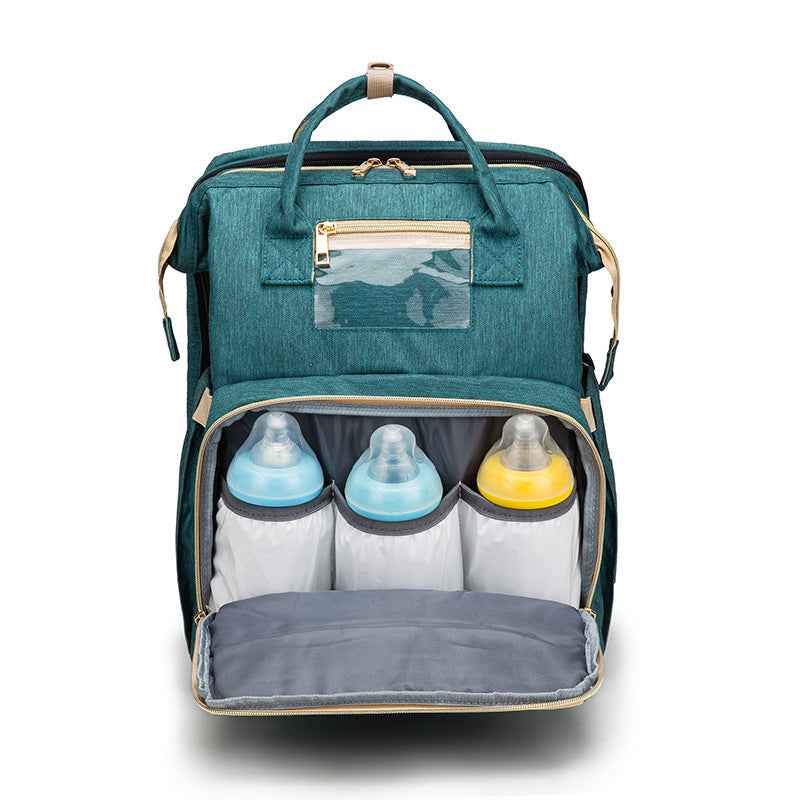 Teal foldable baby travel bed backpack, open front with bottle compartments and liners.