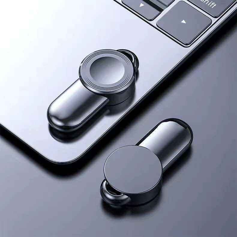 Wireless watch charger dock with magnetic plates in black and silver, close-up angle