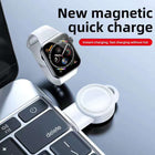 White wireless watch charger dock with magnetic charging plate, close-up with wristwatch