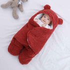 Red quilted baby sleeping bag with hood and bear ears, plush footed legs