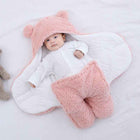 Pink quilted baby sleeping bag with hooded wrap and fuzzy footed legs