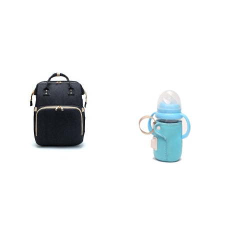 Black baby travel bed backpack with front zip pocket, beige-lined panel, side straps