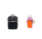 Black foldable baby travel bed backpack with double zipper front and beige edging