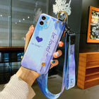 Lavender and blue iPhone case with heart print and attached wrist lanyard strap