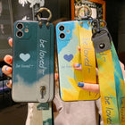 Set of two iPhone cases: teal and blue with heart print and wrist lanyard straps