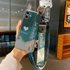 Teal and light gray iPhone case with heart print and attached wrist lanyard strap