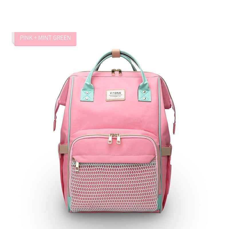 Pink and mint green maternity diaper bag with front mesh pocket and double front zips
