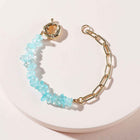 Gold chain bracelet with light blue crystal bead links and spring clasp