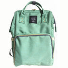 Maternity diaper bag in green with front zipper pocket and black-trim interior panel