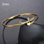 Gold 3mm cuff bangle with engraved cursive name and small heart accent