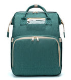 Teal green foldable baby travel bed backpack with beige trim and front double zipper