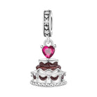 Cake dessert charm with a pink heart gemstone and sparkling crystal details