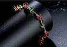 Rose gold crystal cuff bracelet with red and green stones in bezel settings