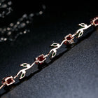 Silver-tone crystal cuff bracelet with red stones and green accents