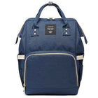 Maternity diaper bag in denim blue with front zipper panel, top handle, and side pockets