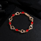 Gold-tone charm bracelet with red heart rhinestone links and heart-shaped clasp