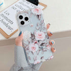 Floral iPhone phone case with pink roses, gray-green leaves, and clear shockproof corners