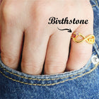 Gold-tone infinity knot ring with round multicolor gemstones, slim band