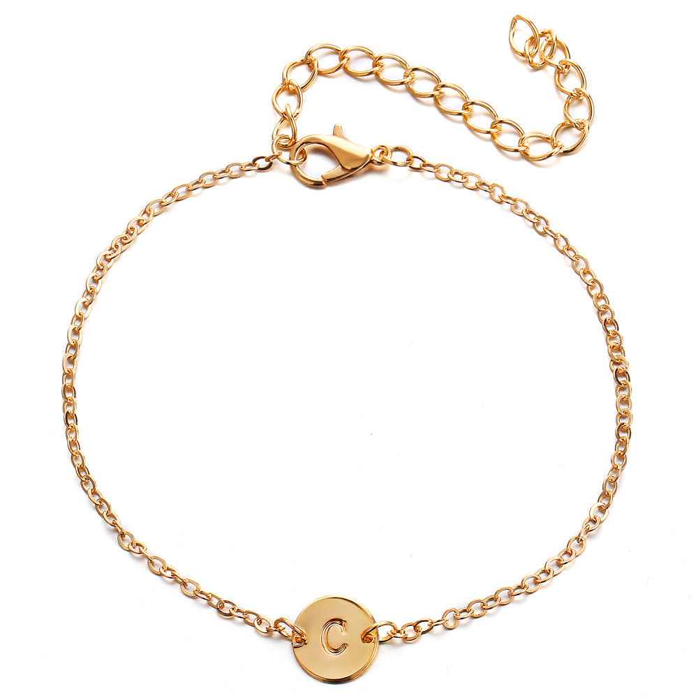 Gold-tone link bracelet with round 'C' charm and lobster clasp