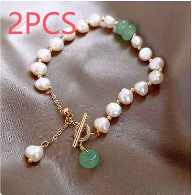 Adjustable freshwater pearl bracelet with white pearls, green beads, and gold hanging charm