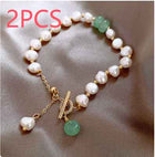 Adjustable freshwater pearl bracelet with white pearls, green beads, and gold hanging charm