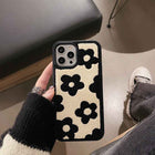 Plush floral iPhone case, cream and black flower pattern; protective raised camera opening