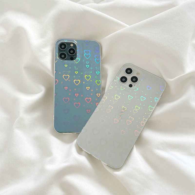 Transparent blue and cream iPhone cases with rainbow heart pattern, visible camera openings