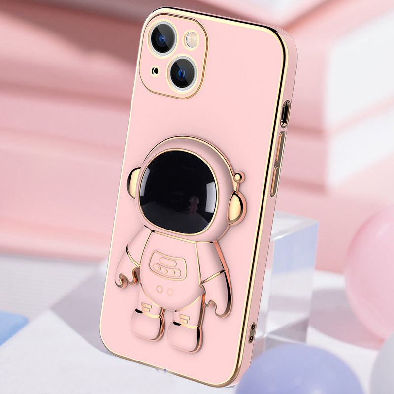 Light pink phone case with 3D astronaut charm, ring grip, and camera cutouts
