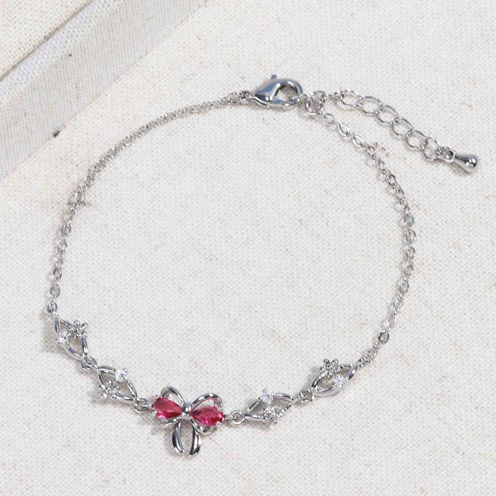 Silver chain bracelet with pink heart rhinestone center bow and adjustable clasp