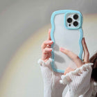 Sky blue silicone iPhone case with wavy candy border and raised camera cutouts