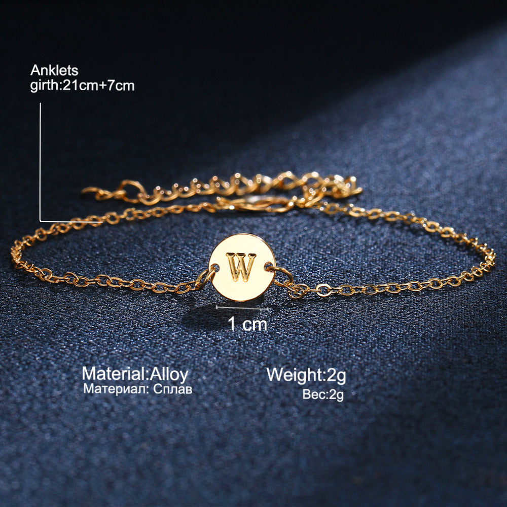 Gold-tone initial bracelet with round charm letter W