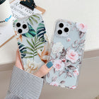 Tropical and floral iPhone cases with clear edges, held side by side