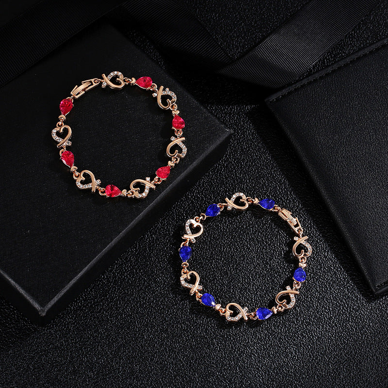 Rhinestone heart charm bracelet with red stones and heart links with crystal accents