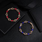 Rhinestone heart charm bracelet with red stones and heart links with crystal accents