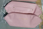 Rose pink travel cosmetic bag with front flap pocket and gold snap hardware