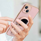 Pink phone case with 3D astronaut charm, ring grip, and camera cutouts