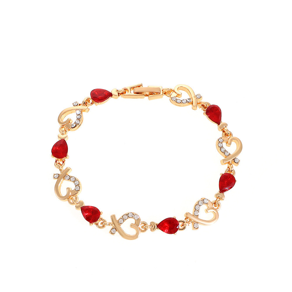 Rhinestone heart charm bracelet with red stones and heart links with crystal accents