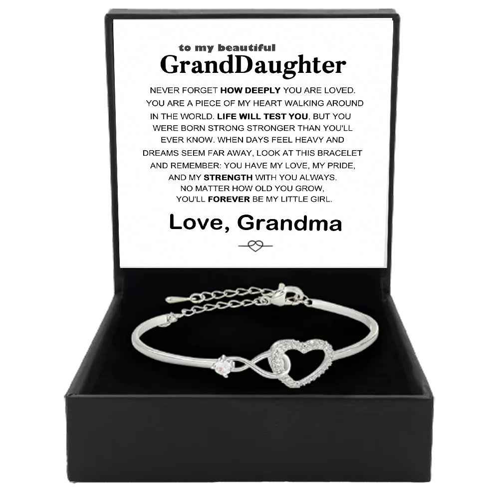 Silver open cuff bracelet with linked heart charm and crystal-like stones