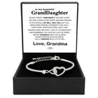 Silver open cuff bracelet with linked heart charm and crystal-like stones