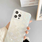 Cream transparent iPhone case with holographic heart pattern, raised camera openings