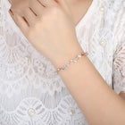 Silver-tone crystal cuff bracelet with clear stones on a wrist